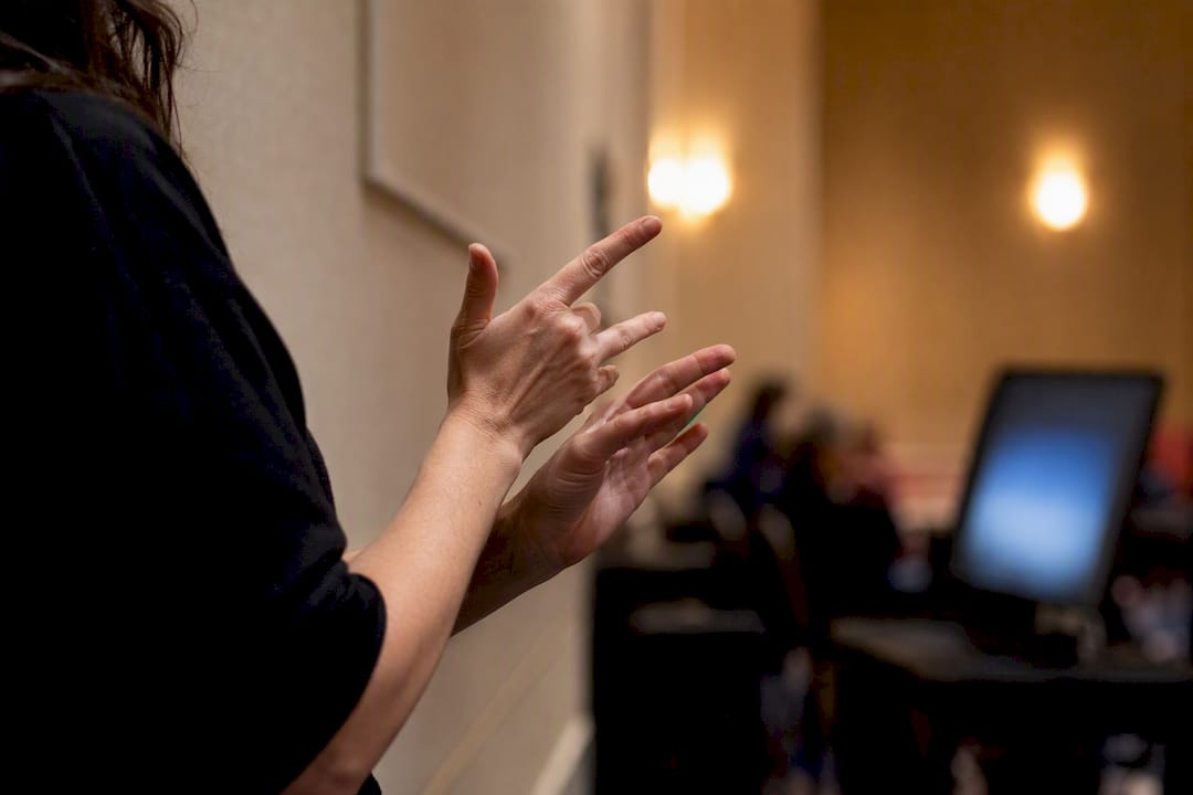 Silhouette of sign language interpreter signing