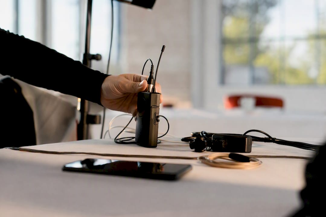 Hand holding wireless microphone near smartphone