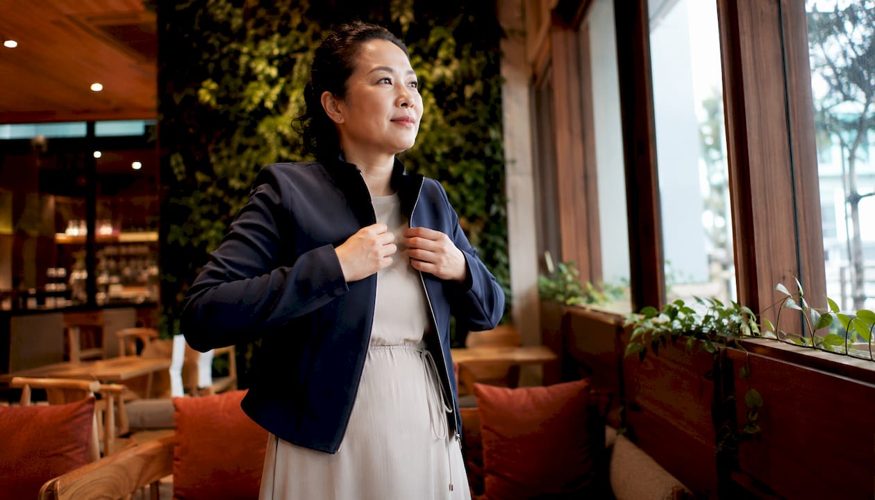 Woman layering jacket over church dress