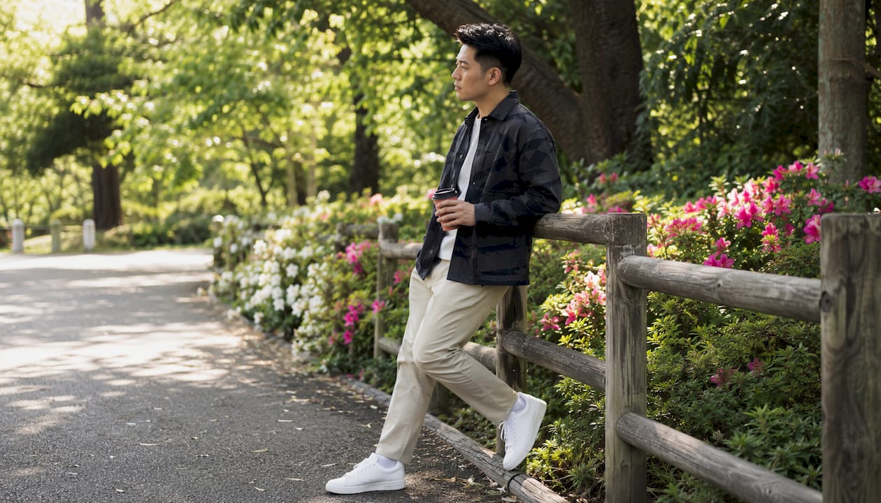 Man modeled in olive utility jacket with chinos in alley