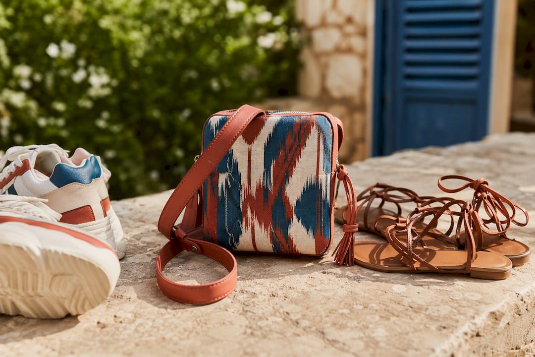 Close-up of summer shoes and crossbody accessories