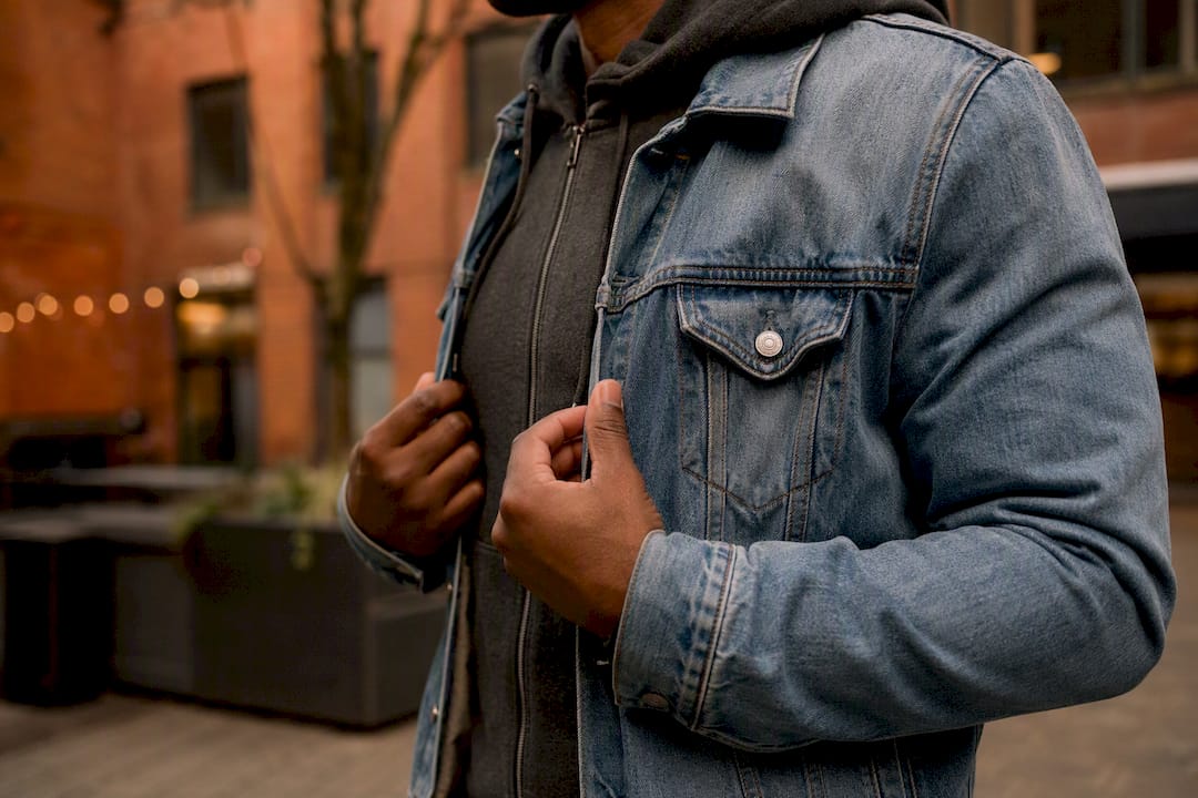 Layering hoodie under denim jacket close-up