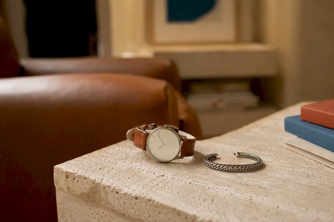 Leather watch and ethical jewelry close-up