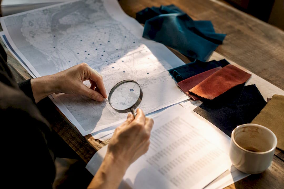 Hands examining factory supplier map
