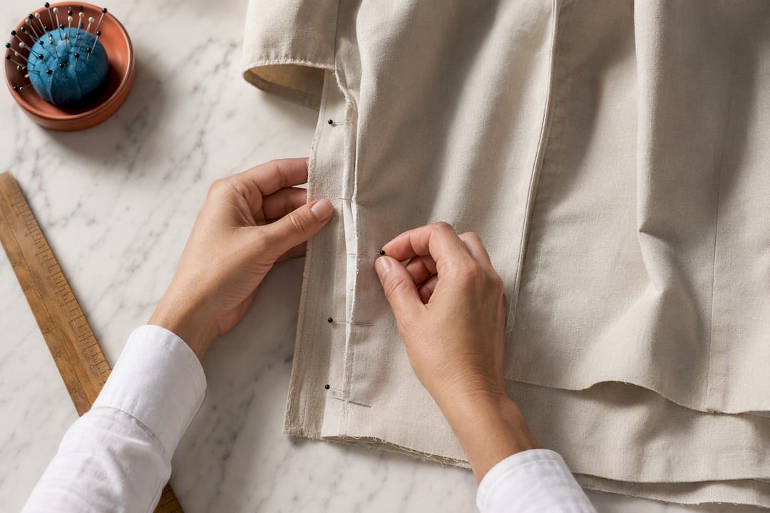 Tailor pinning a garment side seam