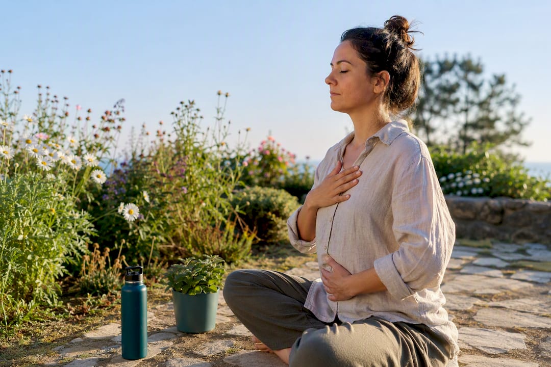 Woman practicing box breathing on yoga mat