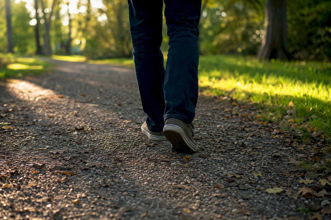 Person's legs walking outdoors in morning light