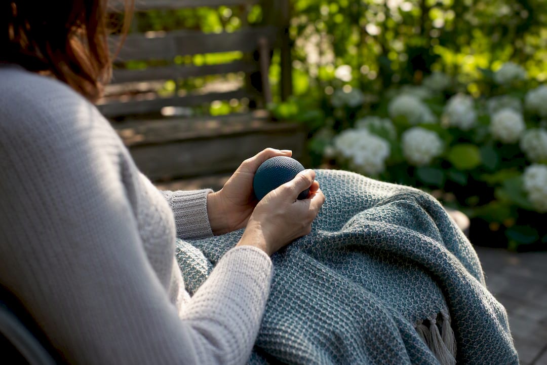 Hands squeezing stress ball for calming