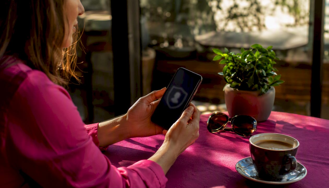 Hands holding phone with profile verification