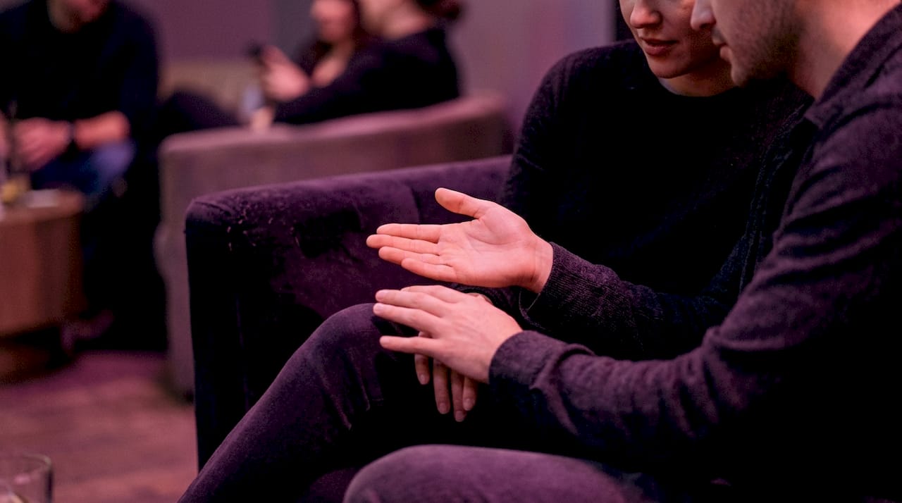 Subtle hand gesture signaling consent in club lounge