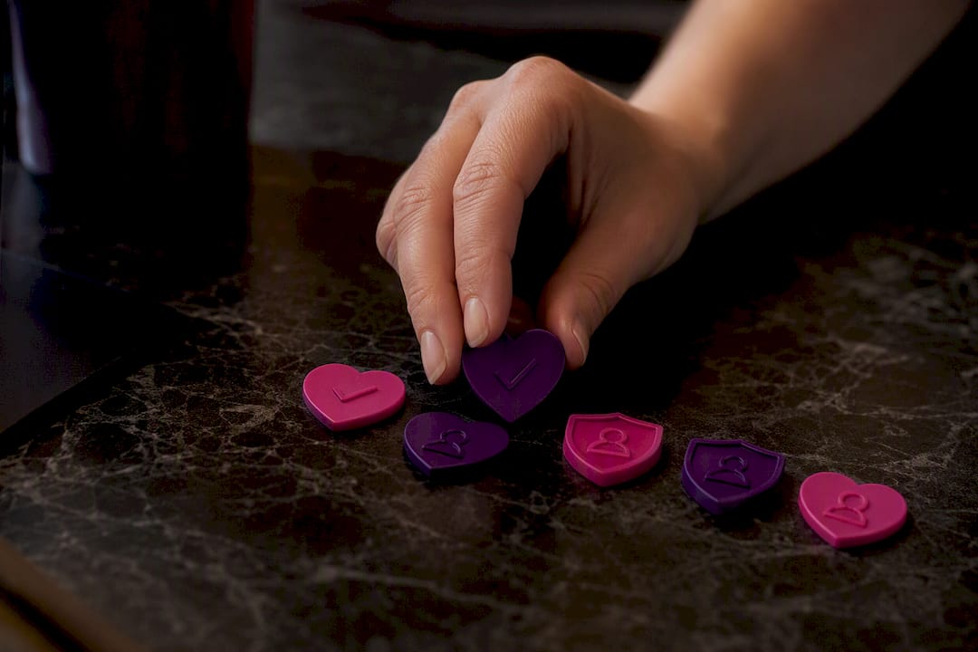 Hand distributing verification tokens on table