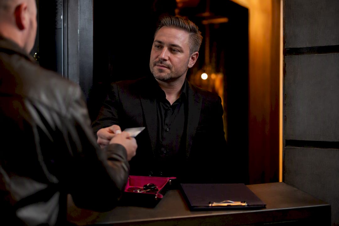 Host checking guest identification at entrance