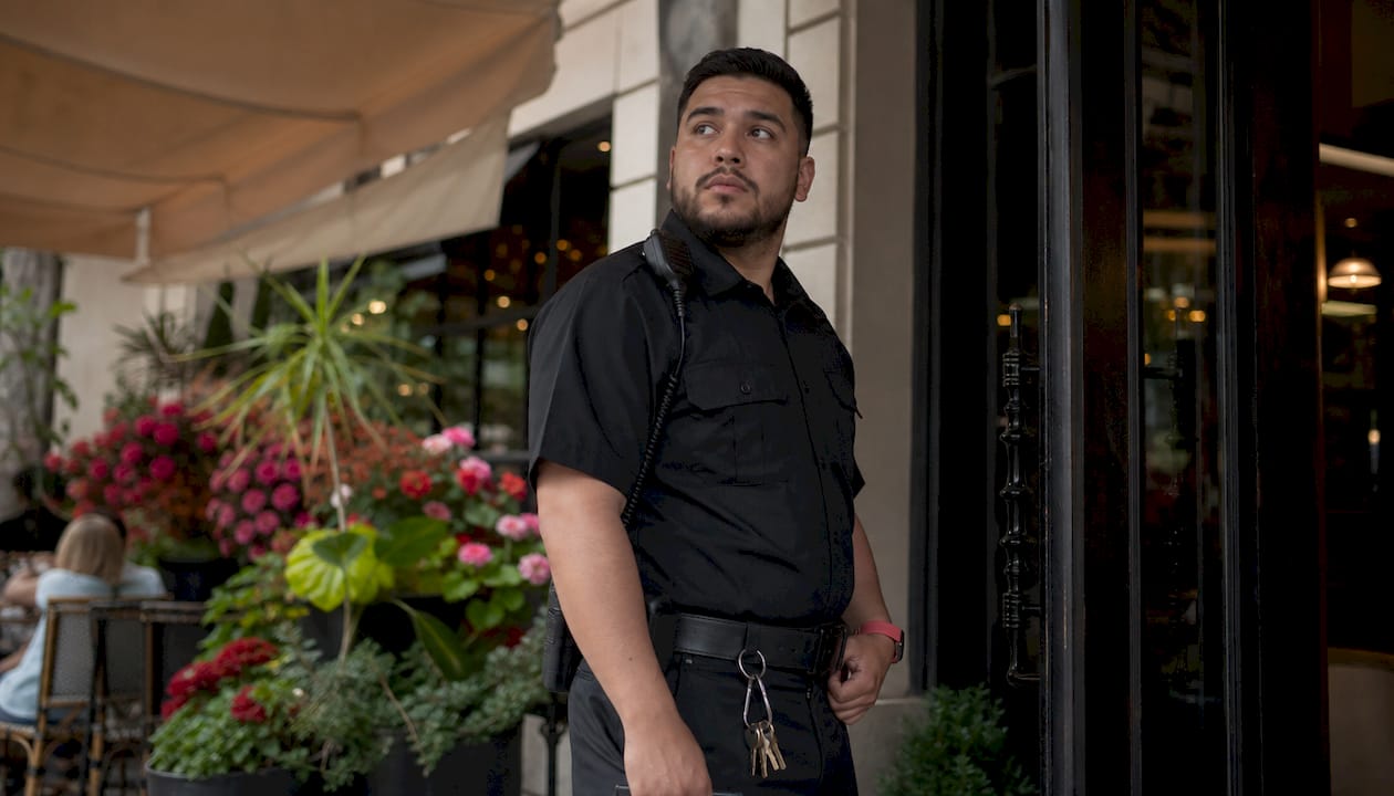 Unarmed security guard monitoring mall entrance