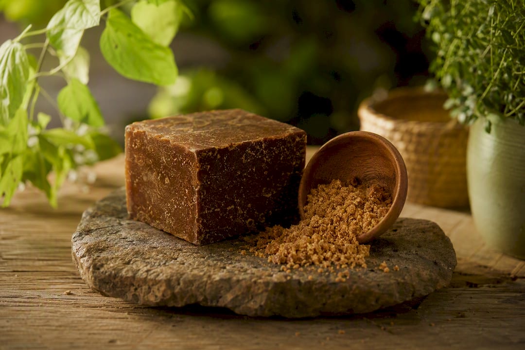 Block and granulated panela sugar on board