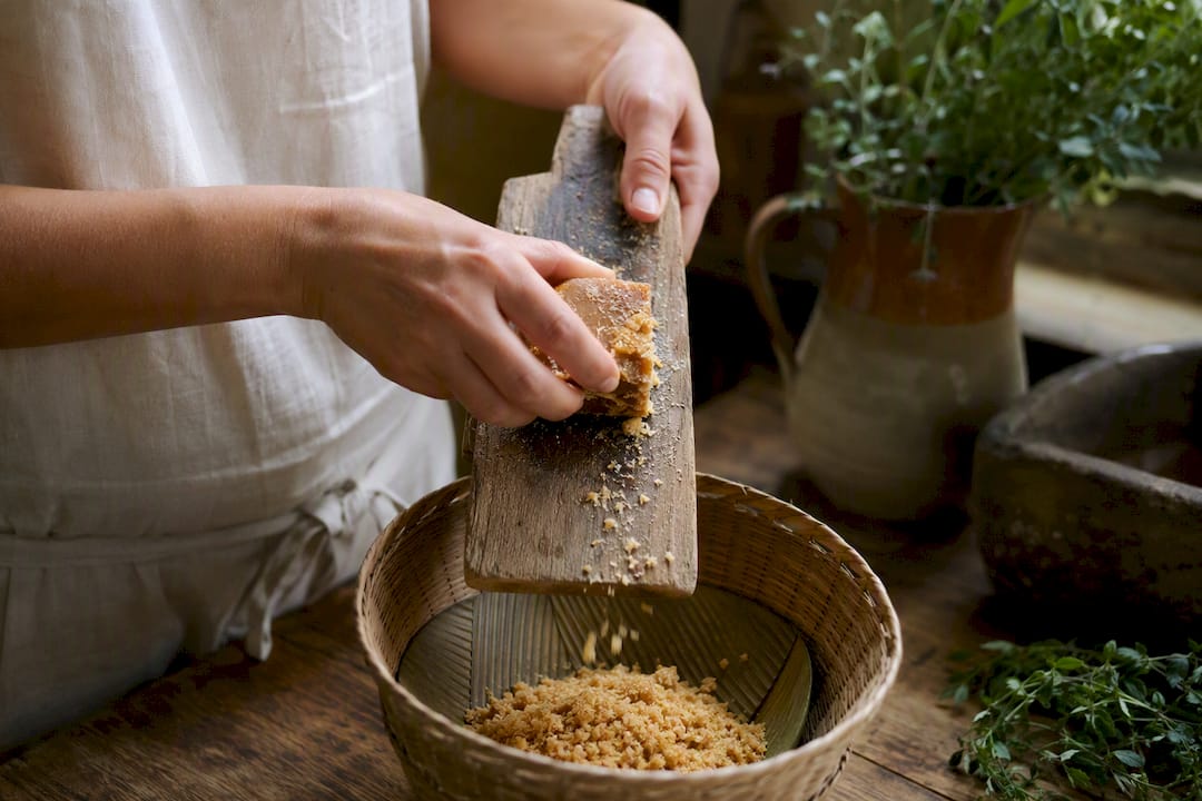 Hand grating panela sugar block