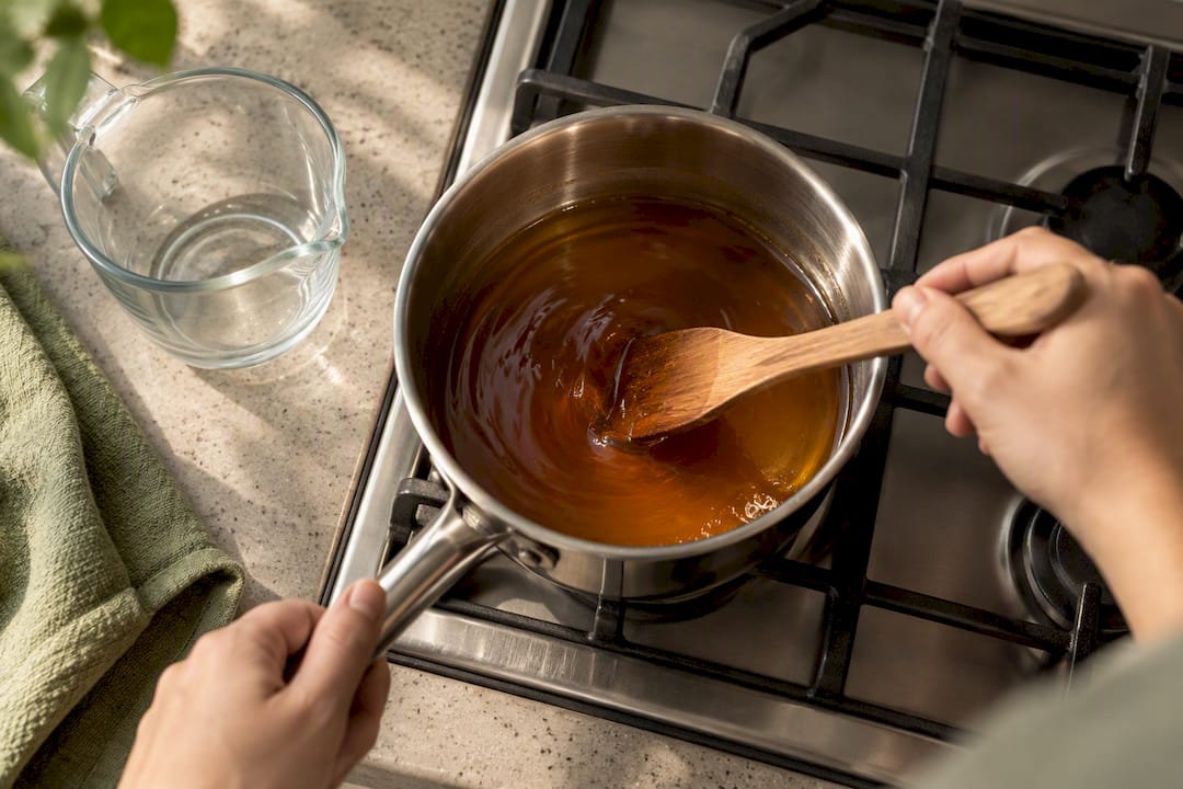 Panela dissolving gently in a saucepan