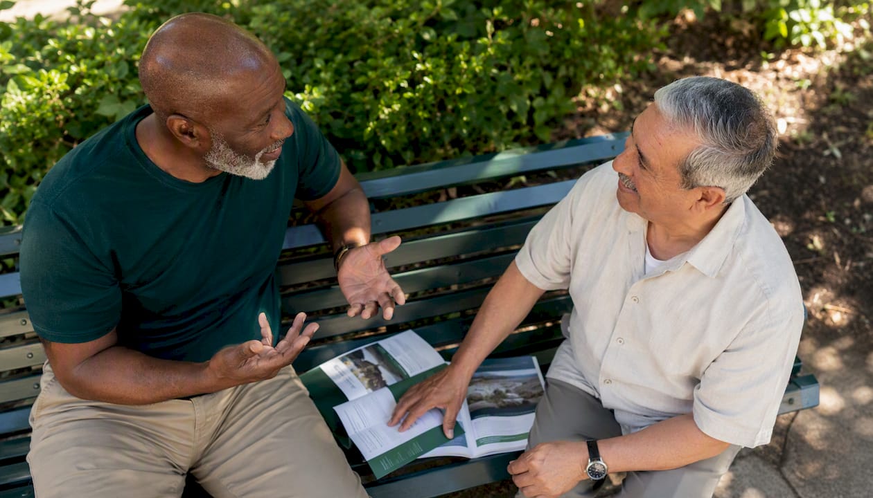Two seniors discussing term life insurance brochures