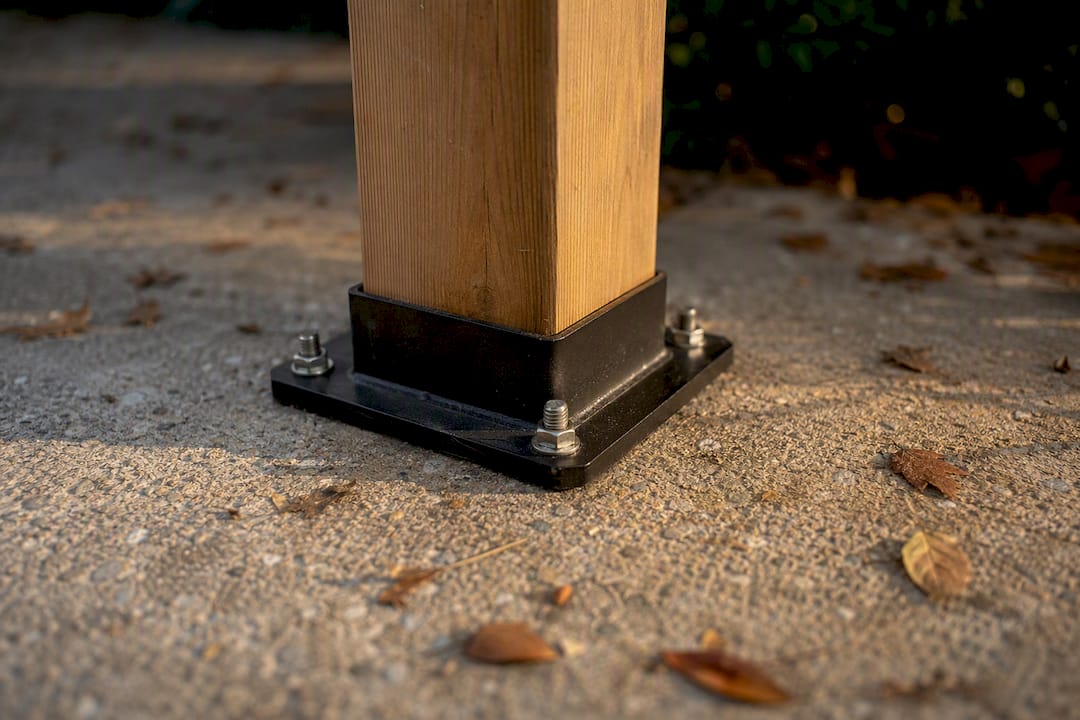 Deck railing post anchored to concrete patio