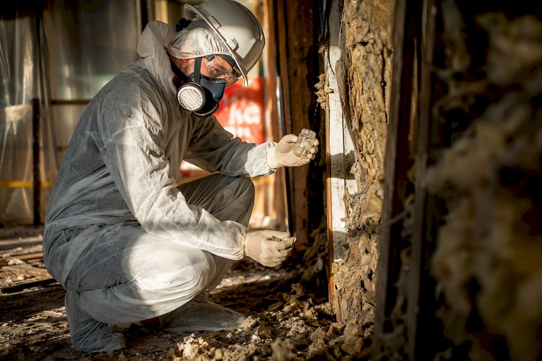 Technician safely inspecting demolition debris sample