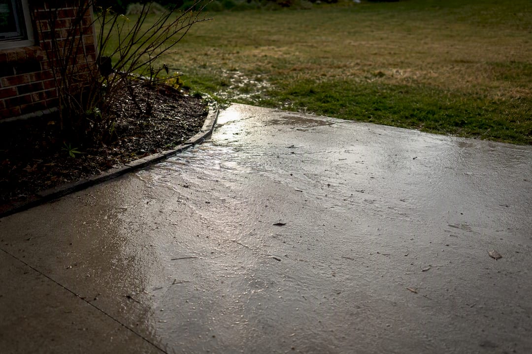 Wet impervious concrete patio with runoff water