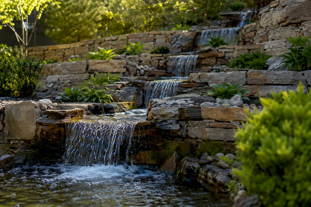 Tiered cascading waterfall on backyard slope