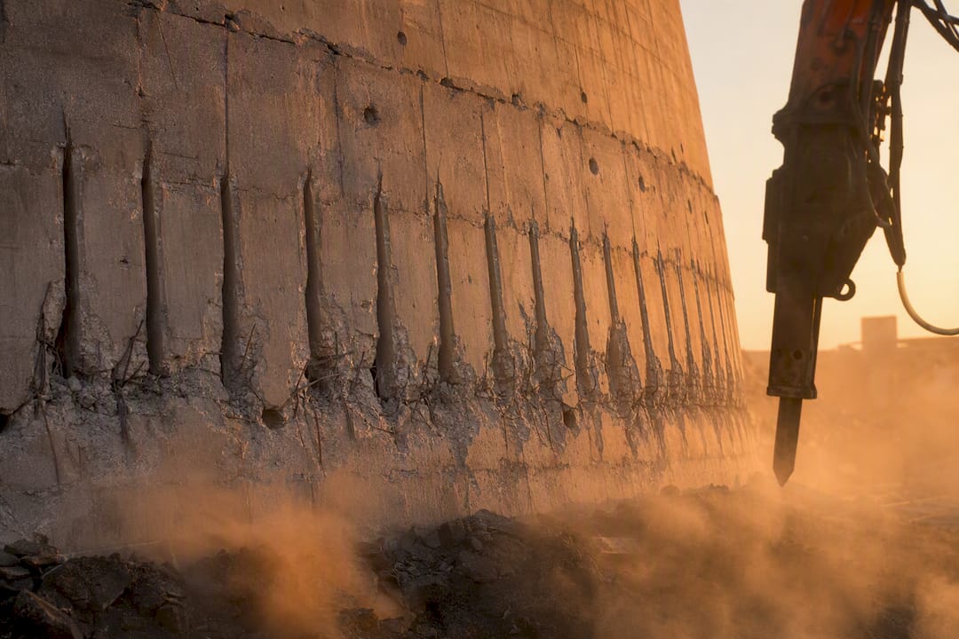 Pre-weakening slots cut in cooling tower concrete