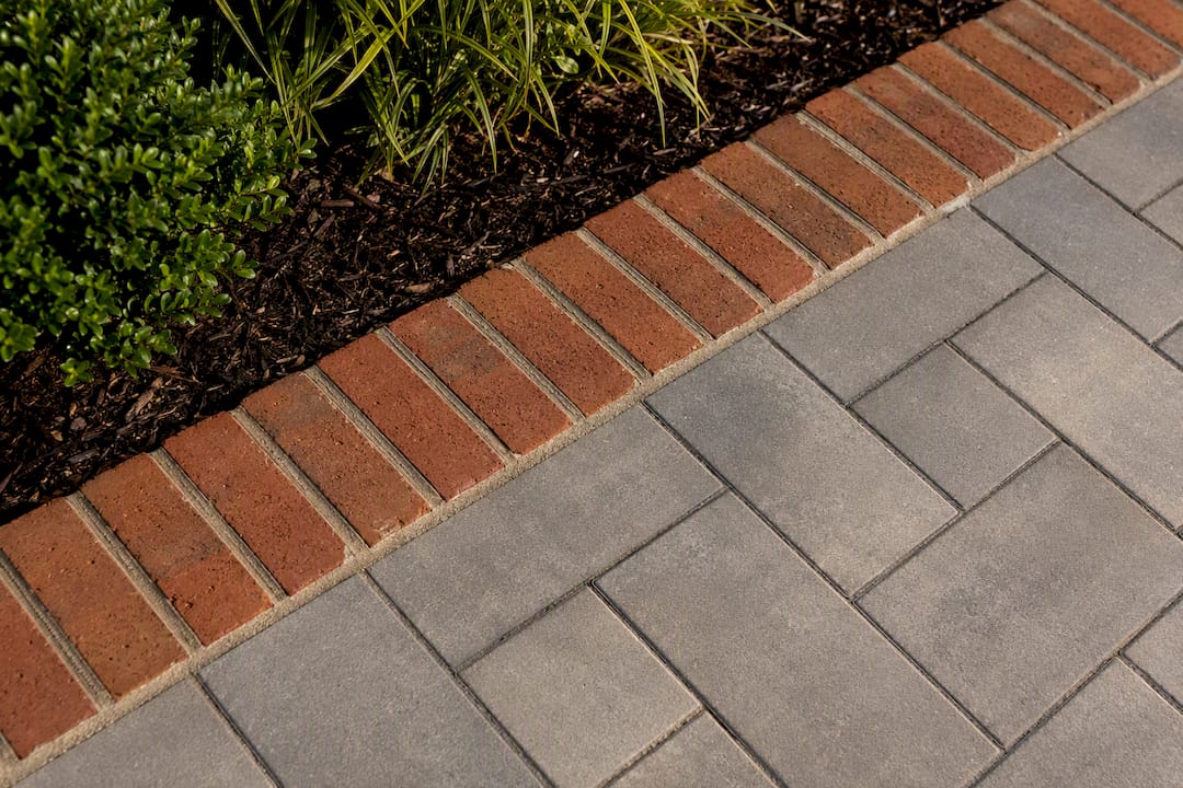 Brick soldier course edging beside patio pavers