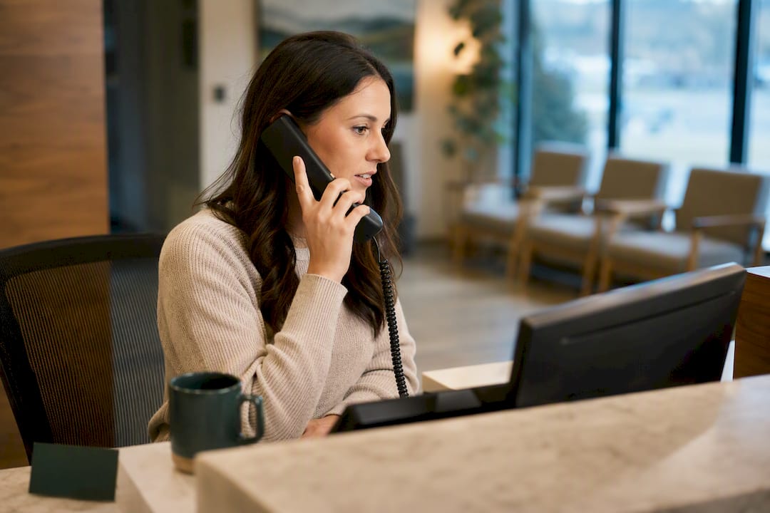 Receptionist verifying Medicare billing status