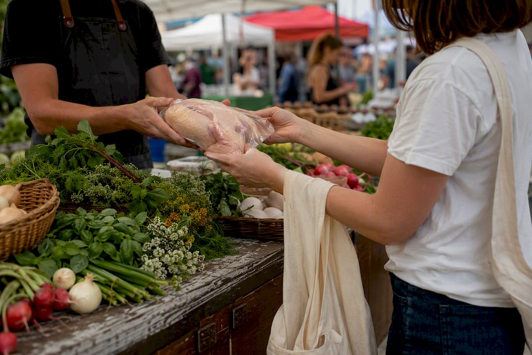 Hands selecting discounted fresh groceries