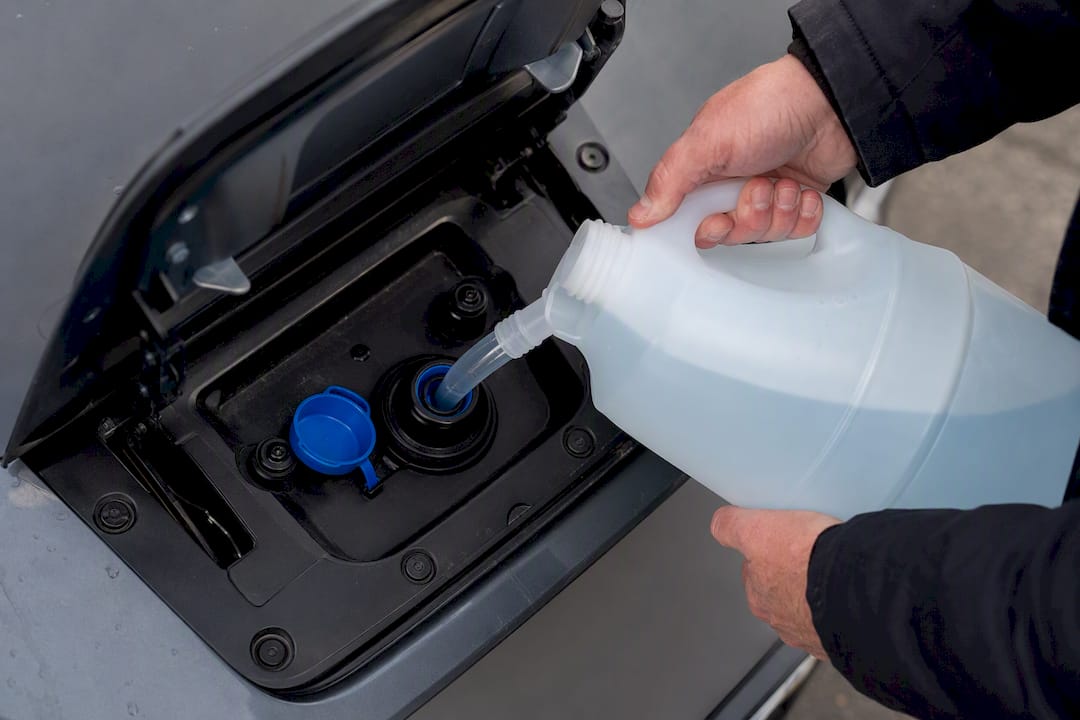 Driver topping up AdBlue filler