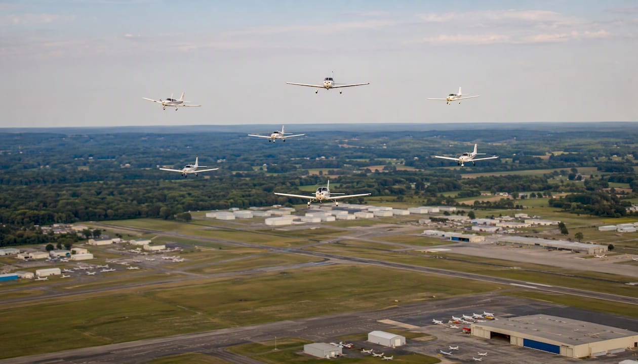 Training aircraft in flight pattern over GA airport