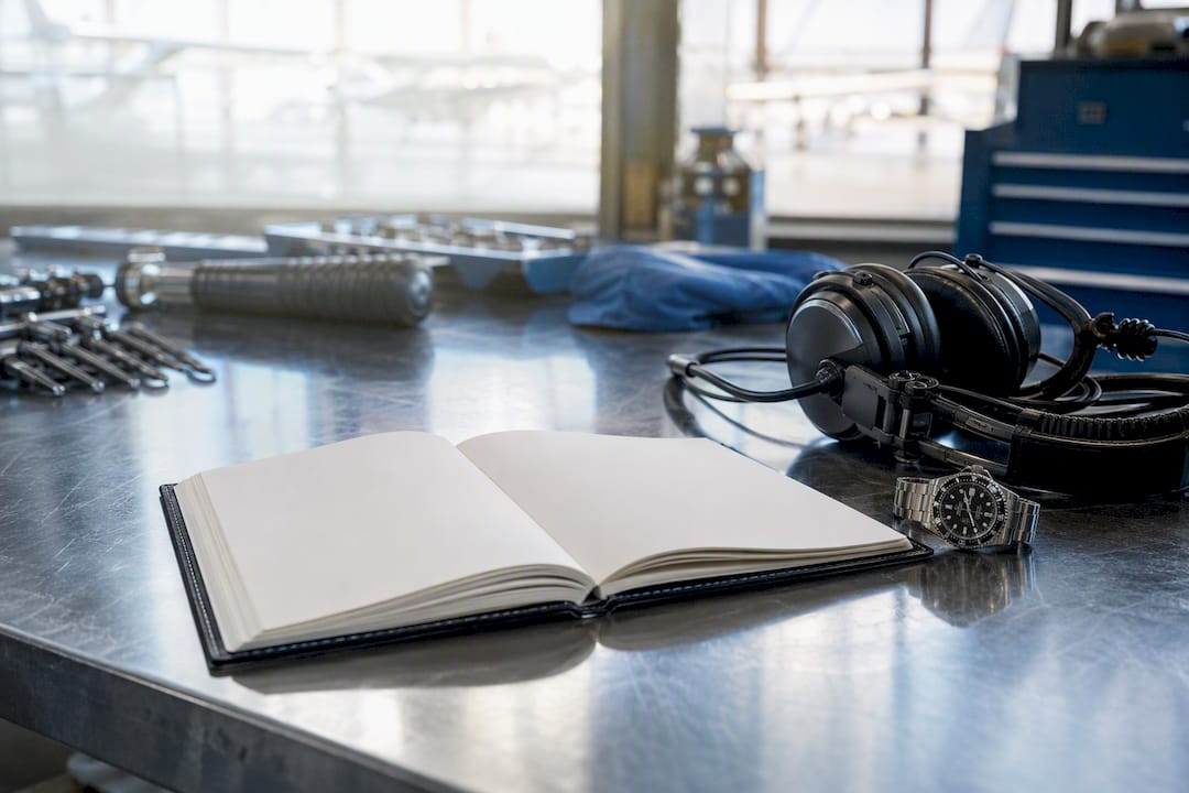 Maintenance logbook with headset on workbench