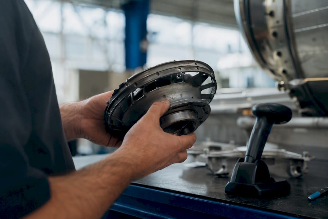 Hands inspecting tagged aircraft engine component