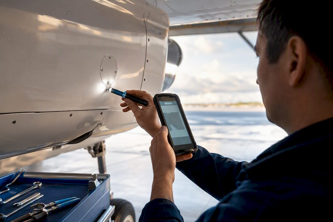 Technician photographing aircraft inspection evidence