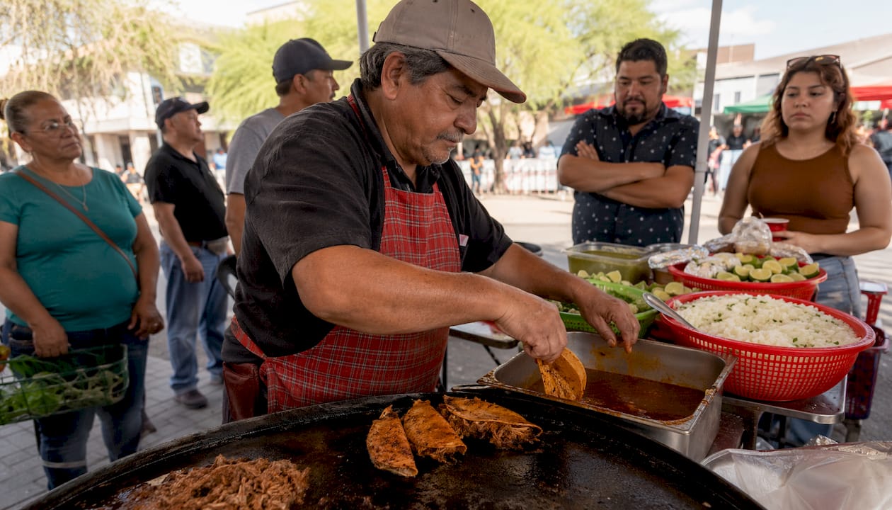 Street vendor grilling birria tacos outdoors