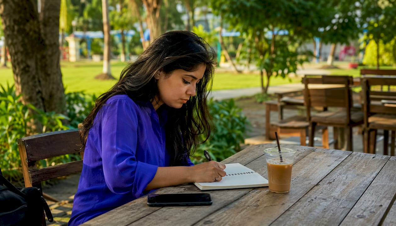 Woman writing notes during proposal capture phase