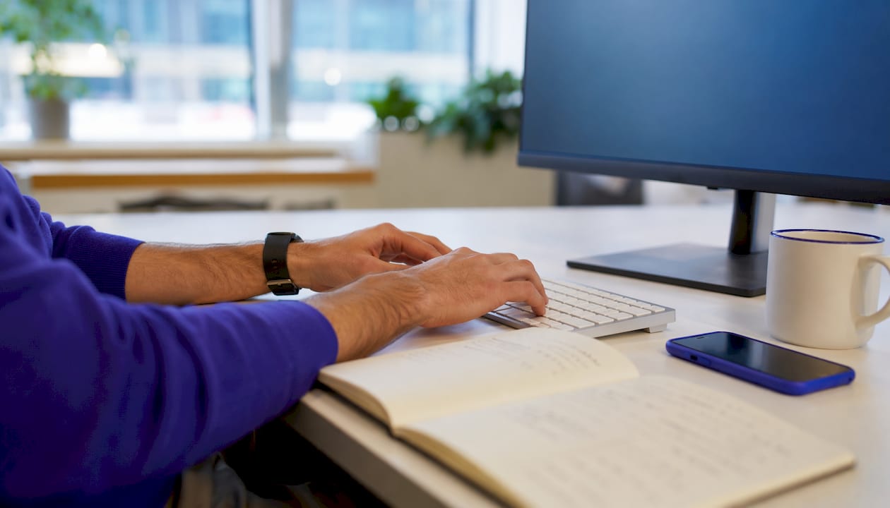 Hands typing on keyboard at AI RFP workspace