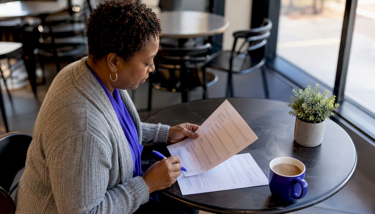Woman reviewing proposal compliance checklist