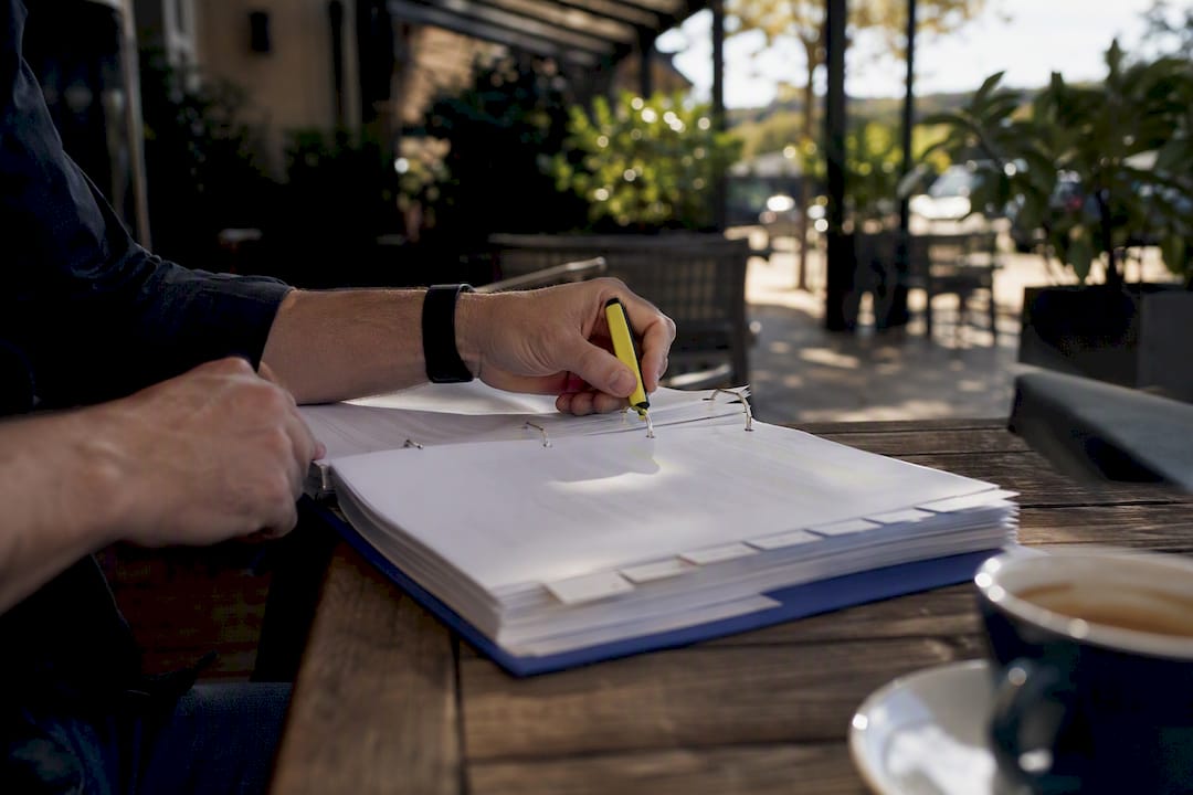 Hands highlighting blank RFP binder pages