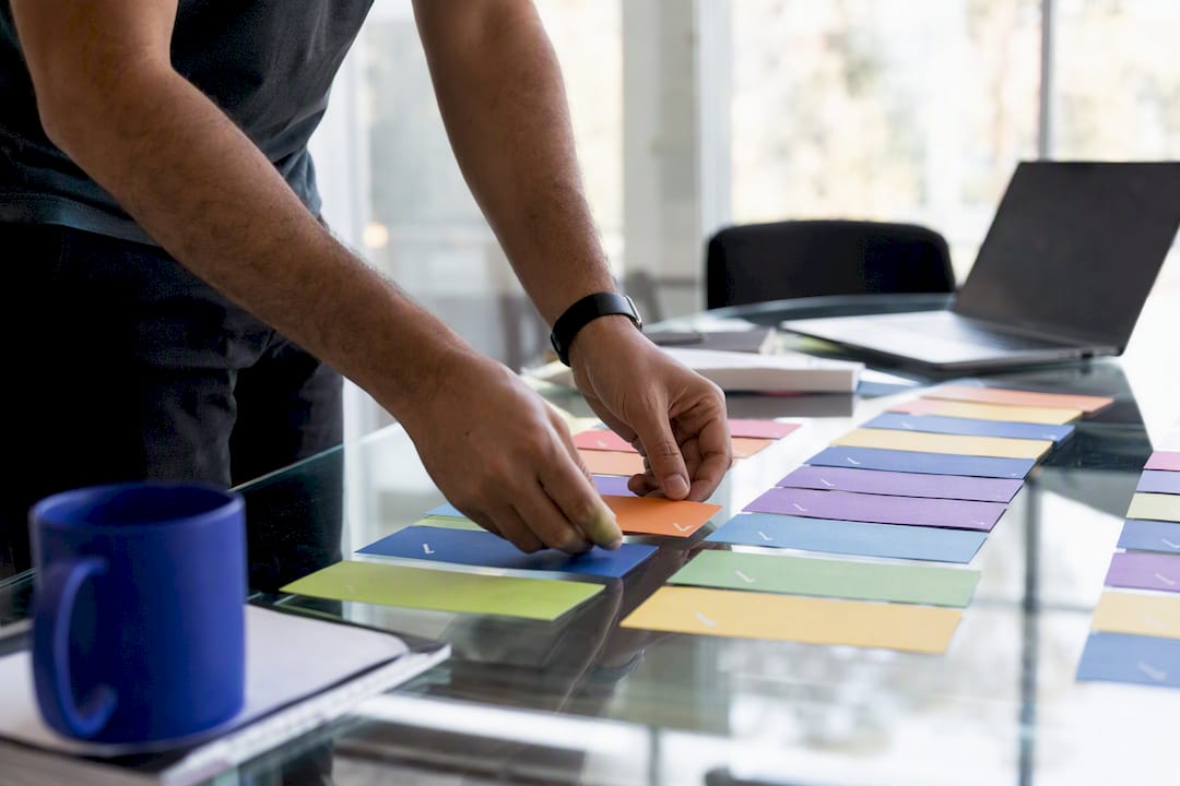 Hands arranging physical test tokens on table