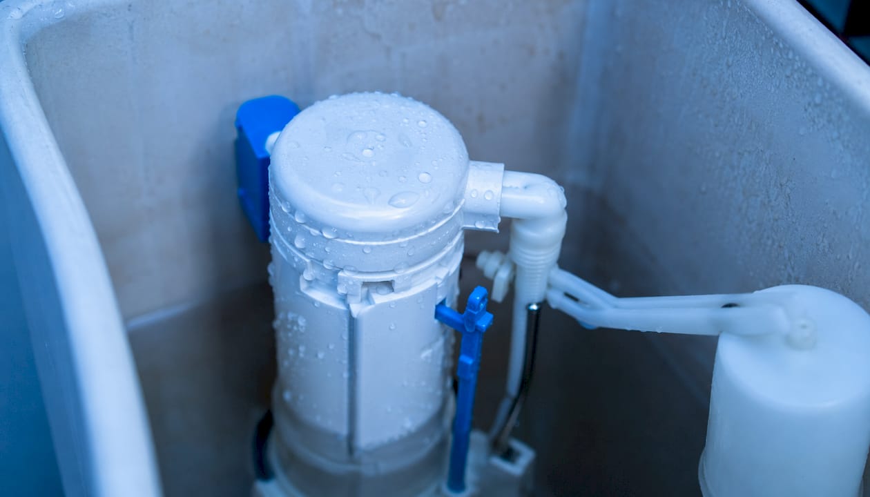 Fill valve inside toilet cistern close-up