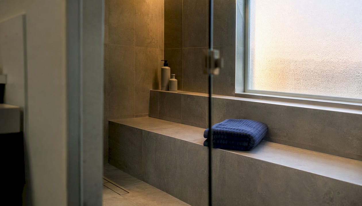 Built-in tiled bench inside walk-in shower