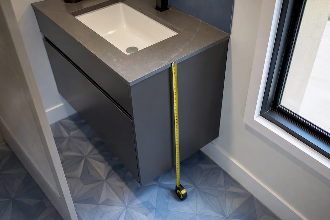 Measuring vanity unit height next to cabinet