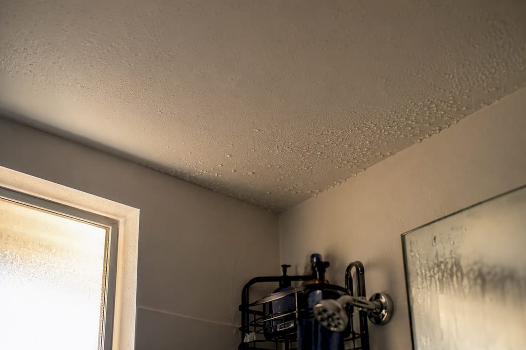 Condensation forming on bathroom ceiling above shower