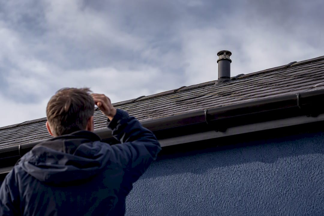 Plumber inspecting a blocked bathroom vent pipe