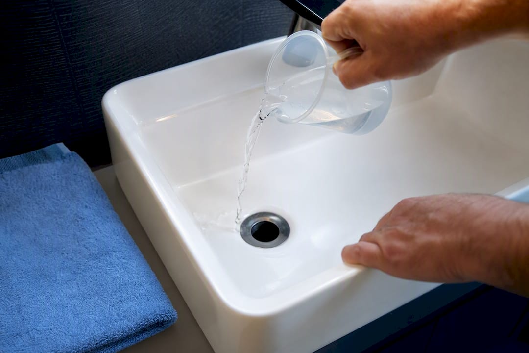 Water being poured into a dry sink trap
