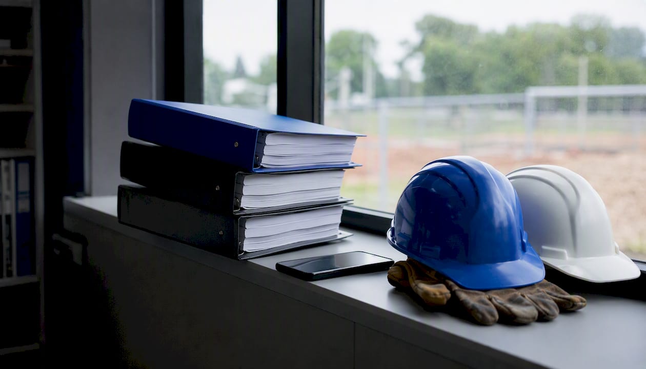 Document binders and safety gear on bench