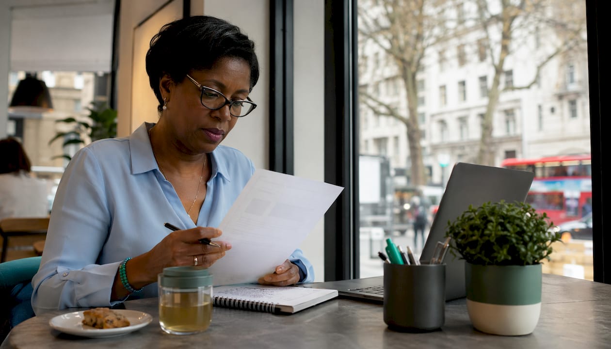 UK finance professional reviewing invoices
