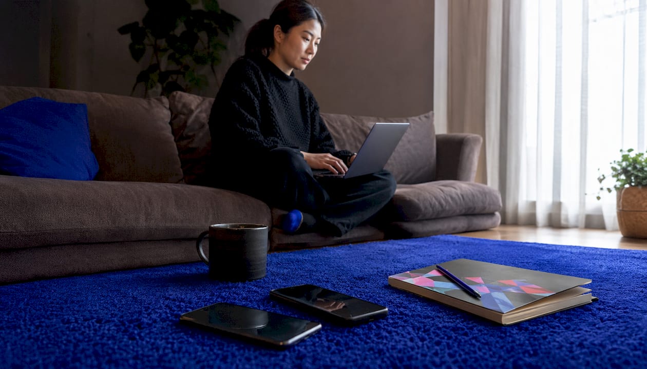 Workspace with laptop and phones comparing onboarding devices