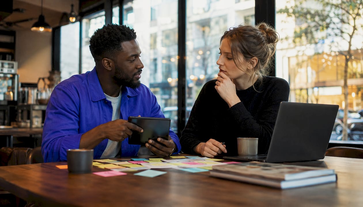 Colleagues discussing onboarding flow ideas at office